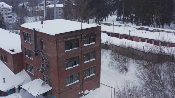 Brick Facade of the Industrial Building Against the Background of the Winter Landscape