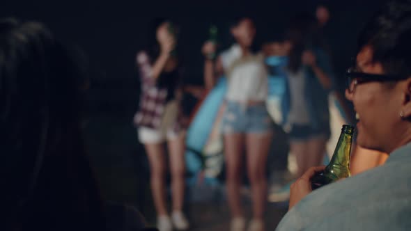 Group of Asia best friends teenagers lady dancing and drinking have fun salute toast of bottle beer.