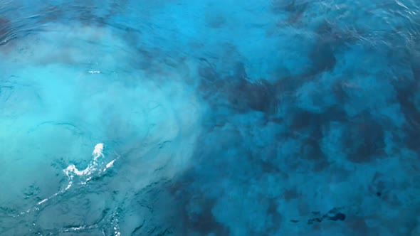 A ships motor causes a sandstorms some 40 feet below on the harbor bottom. alt