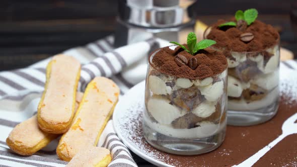 Classic Tiramisu Dessert in a Glass on Wooden Background alt
