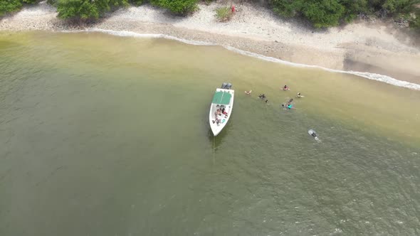 A 360 drone shot of a boat in Chacachacare island located off the north west coast of Trinidad and T alt