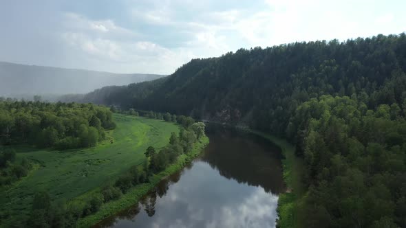 Aerial View of Beautiful River Among Green Forest and Meadow alt