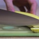 A Man&#39;s Hand Cuts a Banana on the Table with a Knife - VideoHive Item for Sale