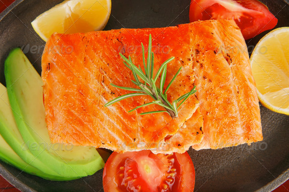 hot baked salmon piece served with vegetables