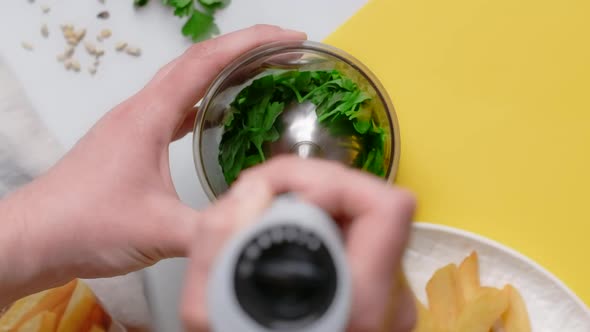 Vertical Flat Lay Video Chef Blends Parsley and Sunflower Seeds By Blender