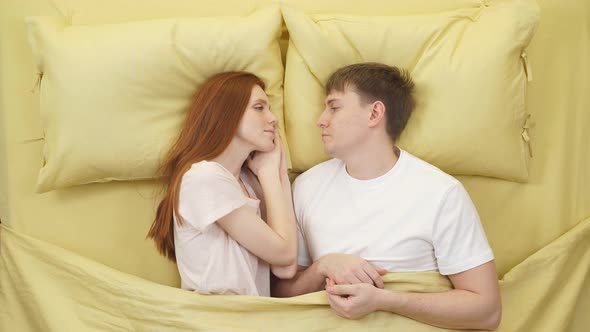 Adorable Caucasian Young Couple Fall Asleep Together in Bed Sleeping at Night