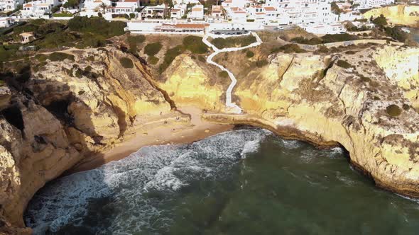 Waves crashing into sandstone cliffs in Carvoeiro, Algarve, Portugal alt