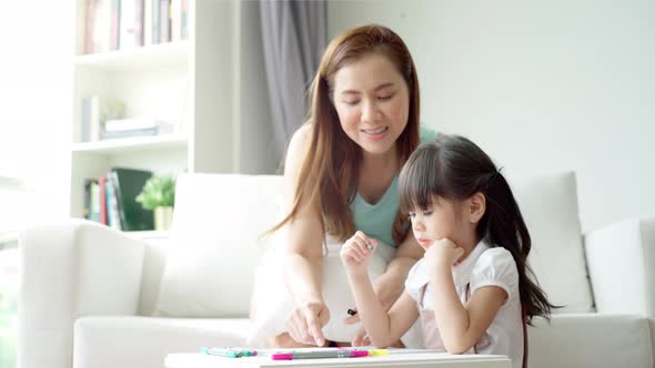 An Asian mother Teaching Her Daughter to Draw 05 alt