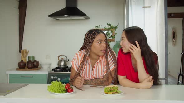 African American Woman Choosing Burger or Healthy Food to Eat Indoors alt