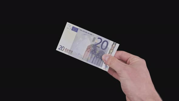 Male Hand Shows a Banknote of 20 Euros with Alpha Channel alt