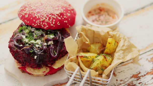 Homemade Vegetable Beetroot Burgers. Red Colored Sesame Bun. Served with Goat Cheese, Feta alt