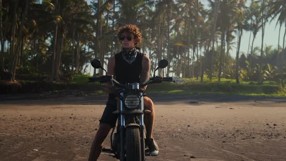Traveller Stopped His Bike on Sandy Shore to Enjoy a Splendid View alt