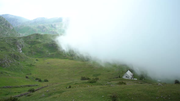 Thick White Fog Covers Mountains and Buildings in Northern Montenegro alt
