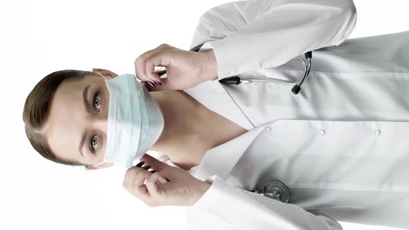 Vertical Shot Young Beautiful Lab Technician in Medical Uniform Put on Protective Mask