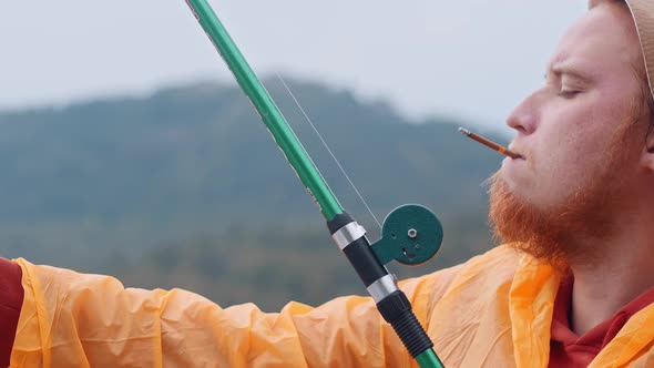 Lonely Man Smoking a Cigarette on Fishing alt