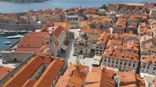 Aerial tilt down shot of the old town of Dubrovnik,Croatia with the view of a cathedral in front of alt