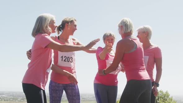 Athletics women hugging each other alt
