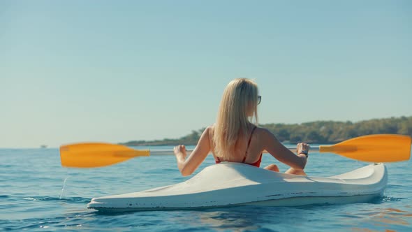 Girl In Kayak Summer Trip. Woman Exploring Calm Sea By Canoe On Holiday Vacation Weekend. alt
