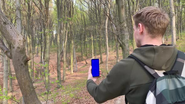 White Male Tourist Checking Navigation Mobile App Outdoors alt