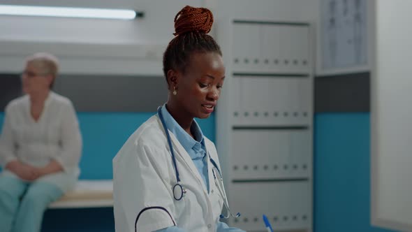 Close Up of Specialist Looking at x Ray Scan with Elder Patient alt