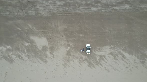 Rising drone car parked on  Inch beach Dingle peninsula Ireland overhead drone aerial view alt