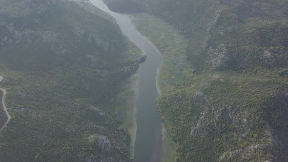 Aerial view of Rijeka Crnojevica. River flows into Skadar lake. Mountains, hills, forest, Montenegro