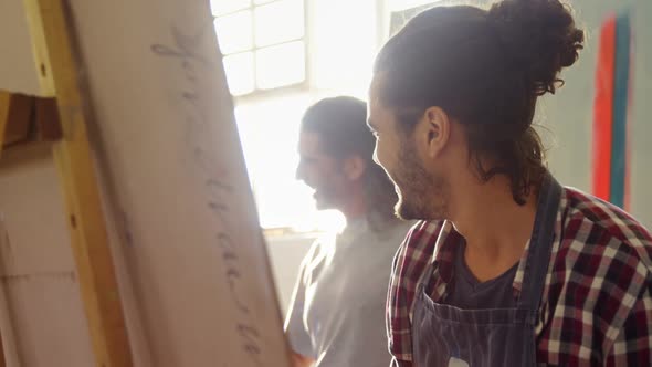 Man painting on canvas 4k alt