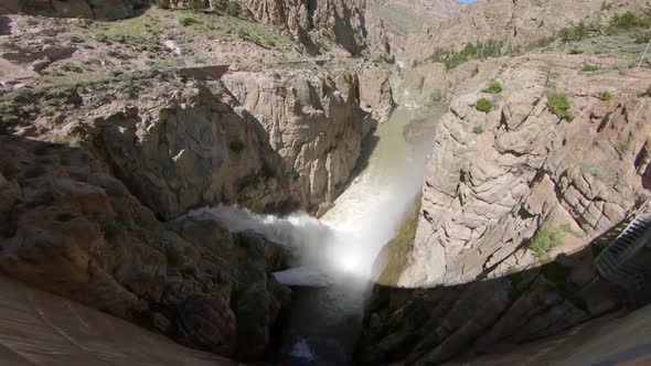 View of water rushing out of Buffalo Bill Dam and flowing through the canyon alt