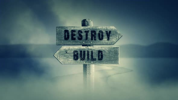 Old Wooden Sign On A Middle Of A Cross Road With The Words Destroy Or Build alt