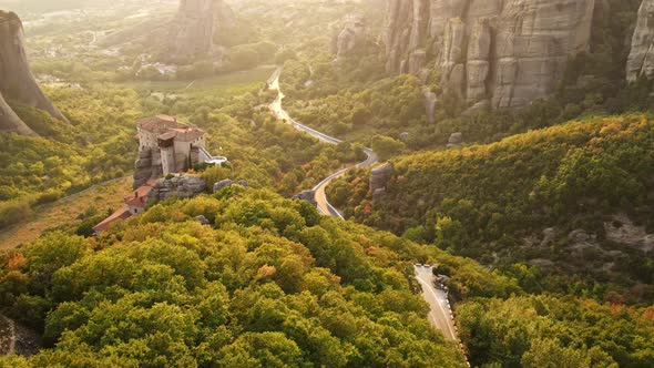 Aerial drone view of the Meteora in Greece at sunset. Rock formations with Orthodox monasteries alt