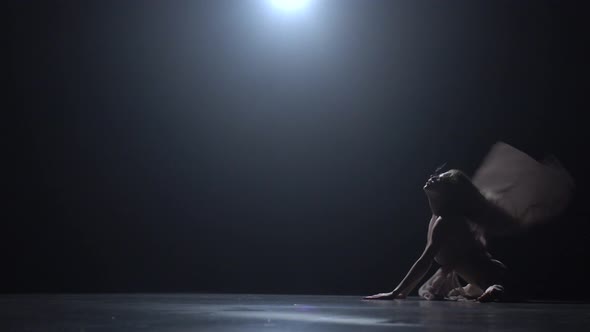 Woman Dancing Contemp in Dark Studio Against Spotlight alt