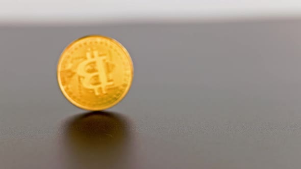 Bitcoin Coin Spinning on Gray Background  Closeup with Slowmo