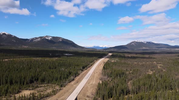 Aerial View Of Highway and Snow Top Mountains Near Nordegg Alberta Cananda alt