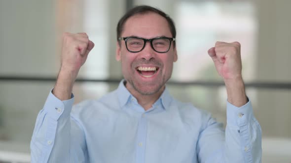 Portrait of Excited Middle Aged Man Celebrating Success alt
