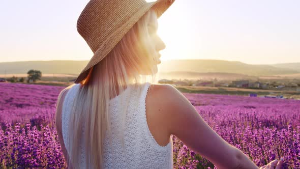 Portrait of a Blonde Woman with Hat in Lavender Fields on Summer