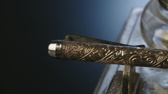 Antique pen and ink on a black reflective surface alt