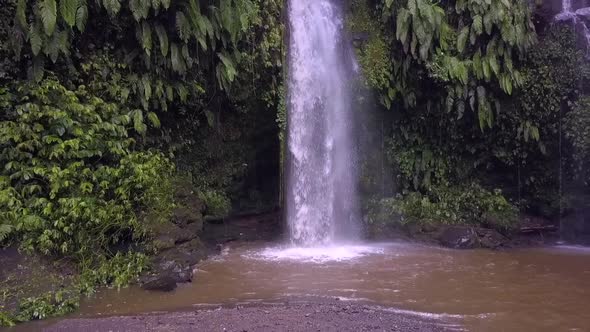 Slow motion native natural shower.Marvelous aerial view flight pull out drone footageWaterfall Ben alt