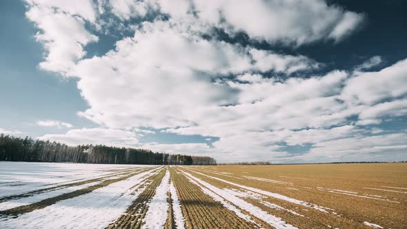 Spring Plowed Field Partly Covered Winter Melting Snow Ready For New Season alt