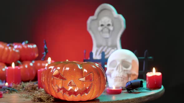 Halloween Decorated Table with a Flashing Red Light on the Black Background alt