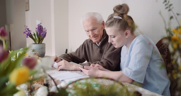Easter Holiday - Young Woman and Senior Man Spending Time Together During Easter Holidays. alt