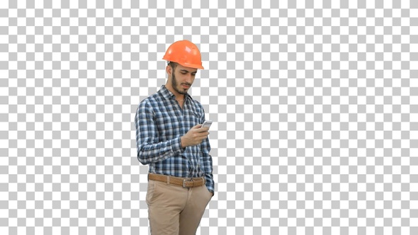 Young manager in helmet using mobile phone, Alpha Channel