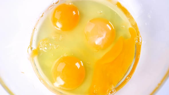 Breaking Eggs in Glass Bowl