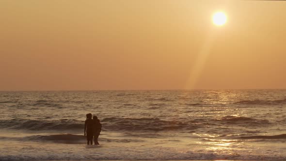 Happy Family Swimming in Ocean Water Backlit By Golden Sunset Light Copy Text Space. Man Woman Kid alt