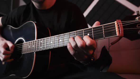 Young Man Playing Acoustic Guitar While Sitting Sofa Home Recording Studio alt