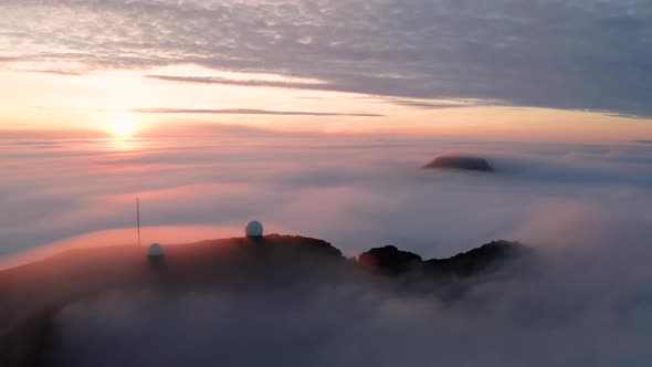 Aerial View of the Mountains in the Clouds at Sunset