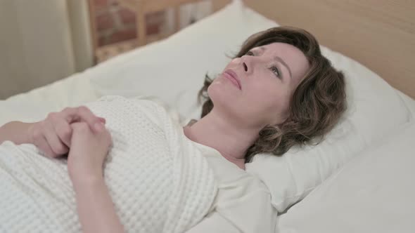 Worried Old Woman Thinking in Bed  alt
