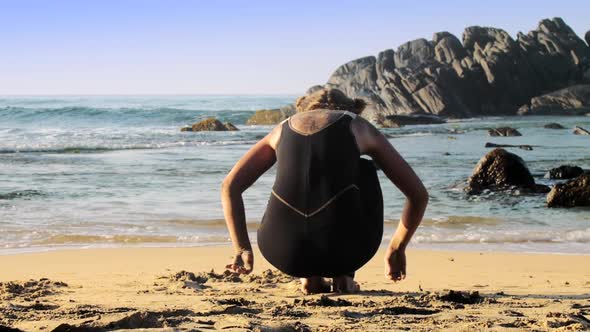 Sporty Barefoot Young Woman Practices Yoga on Sandy Beach alt