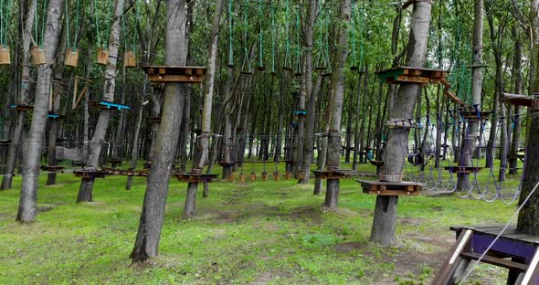 Aerial View Of Forest Adventure Park With Obstacle Courses alt