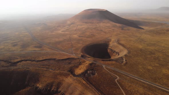 Aerial Tilt up Unveil Shot of Volcanic Crater and Mountain Cone