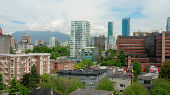 Drone Ascend Over City Street With Panorama Of Modern High-rise Buildings At West End, Vancouver, Ca alt